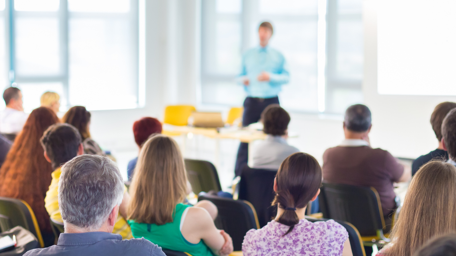 Adults sitting in classroom listening to a presenter